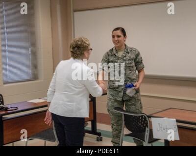 Deliberando Assistente del Segretario della Difesa della manodopera e di affari di riserva Vee Penrod scuote le mani con il Senior Airman Rachel Ulangkaya, 914 Istituto di medicina aeronautica Staging Squadron, Niagara Falls riserva d'aria Station, 14 maggio 2018 durante un tour di funzionamento consentono una maggiore salute Savannah. La manifestazione fa parte della predisposizione innovativo programma di formazione che fornisce nella vita reale la formazione di distribuzione e di disponibilità per il personale militare mentre gli appalti pubblici e della società civile ha bisogno. Foto Stock