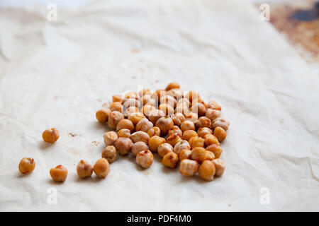 Ceci arrosto con spezie su carta, primo piano. Foto Stock