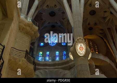 Dettagli architettonici di blu delle vetrate colorate e lampada di Barcellona sulla colonna all'interno di Sagrada Familia - grande incompiuta Chiesa cattolica romana in bar Foto Stock