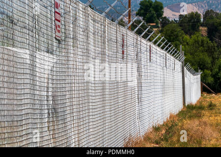 Recinzione a ciclone e filo spinato; sito industriale; Smelledertown, vicino Salida; Colorado; USA Foto Stock