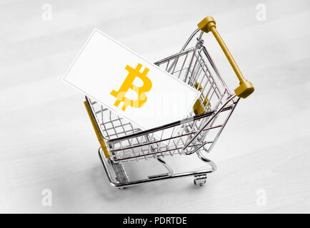 Bitcoin logo su una carta business nel carrello. Acquisto o vendita cryptocurrency concetto. Foto Stock