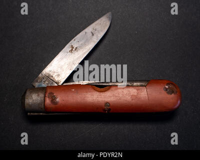 Vintage antique militare svizzero coltello tascabile con utilizzato e lama arrugginita dalla seconda guerra mondiale in cuoio nero lo sfondo Foto Stock