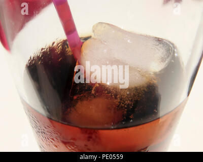 Close up di cubetti di ghiaccio e paglia di plastica nel bicchiere di coca Foto Stock