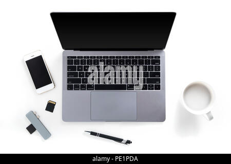 Vista superiore del piano portapaziente con il computer portatile, telefono cellulare, schede di memoria, lettore carta, penna e la tazza di caffè isolato su sfondo bianco Foto Stock