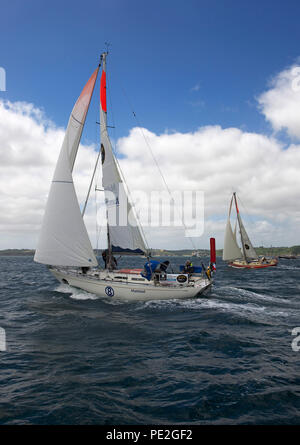 Marinaio francese Jean-Luc Van Den Heede vela il suo yacht Malmut di Falmouth allo start della gara di alimentatore per il 2108 Golden Globe Race (Puffin dietro). Foto Stock