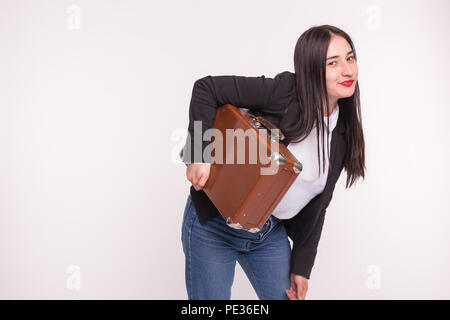 Valigia, viaggi e concetto di persone - donna asiatica holding vecchia valigia marrone su sfondo bianco con spazio di copia Foto Stock