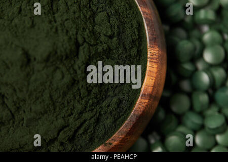 Messa a fuoco selettiva di spirulina pillole e spirulina in polvere nella ciotola Foto Stock