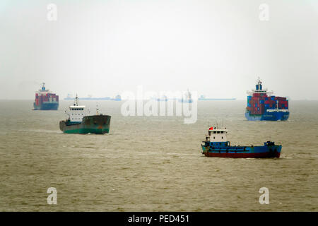 Contenitore di navi e barche da pesca a Shanghai in Cina Asia Mar Cinese Orientale delta del fiume Yangtze Foto Stock