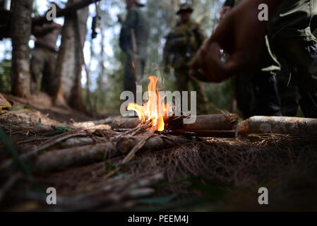 Equipaggi iscritti con la 101st Rescue Squadron costruire un incendio di piccole dimensioni durante un combattimento e acqua di sopravvivenza corso di formazione ad Homestead Air Base riserva Fla., 20 gennaio, 2016. Durante questo corso di formazione, equipaggio membri guadagnato un training di aggiornamento utilizzando il proprio radio emergenza, movimenti tattici attraverso un terreno difficile, come costruzione di rifugi, modi di costruire gli incendi e i metodi per eludere il nemico. (U.S. Air National Guard / Staff Sgt. Christopher S. Muncy / rilasciato) Foto Stock