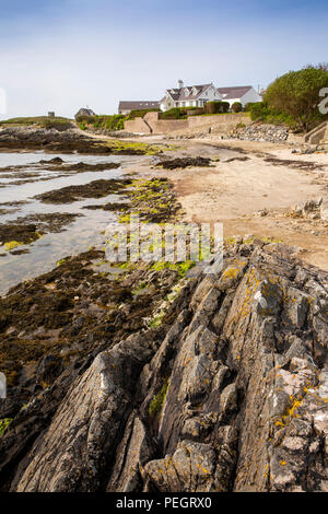 Nel Regno Unito, in Galles, Anglesey, Rhoscolyn, rocce sulla spiaggia con marea sfuggente, Foto Stock