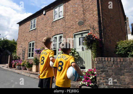 I ragazzi in Wolverhampton Wanderers FC kit replica a giocare a calcio al di fuori del luogo di nascita di lupi e Inghilterra leggenda calcistica di Billy Wright in Ironb Foto Stock