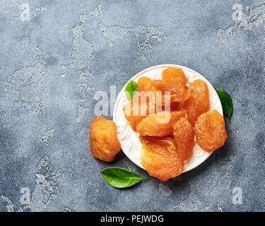 I canditi di Fette di pera. Frutta secca su sfondo grigio. Vista dall'alto. Foto Stock