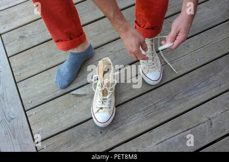 Sezione bassa di un uomo la legatura le sue scarpe lace Foto Stock