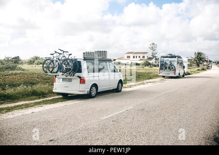 Il Portogallo, Lagos, 12 Aprile 2018: automobili per viaggiare con le biciclette parcheggiate a lato della strada. Il riposo attivo e viaggi in famiglia. Foto Stock