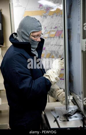 SASEBO, Giappone (feb. 11, 2016) l'ENS. Lara Yamada scrive le informazioni sui danni di un plottaggio di controllo di bordo durante una spazio principale drill incendio a bordo il trasporto anfibio dock nave USS Green Bay (LPD 20). Green Bay è attaccato al Bonhomme Richard anfibio gruppo pronto (ARG) e attualmente è in un selettivo disponibilità limitata (SRA). (U.S. Foto di Marina di Massa lo specialista di comunicazione 2a classe Chris Williamson/rilasciato) Foto Stock