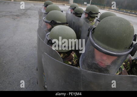 Soldati rumeni di 265Polizia Militare Battaglione protezioni di interblocco durante la conduzione di folla antisommossa durante la formazione di una forza per il Kosovo (KFOR) Missione prove generali di esercizio (MRE) al giunto multinazionale Centro Readiness in Hohenfels, Germania, Feb 18, 2016. La KFOR MRE 21 è basato sull'attuale ambiente operativo ed è progettato per preparare l'unità per il sostegno della pace e della stabilità e le operazioni di emergenza in Kosovo a sostegno delle autorità civili per mantenere un ambiente sicuro e protetto. (U.S. Esercito foto di Spc. Lloyd Villanueva/rilasciato) Foto Stock