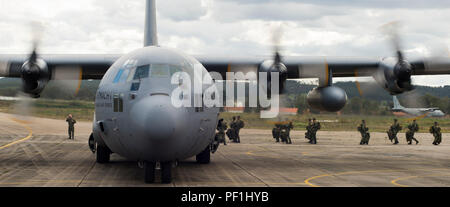 I paracadutisti portoghesi salgono a bordo di un C-130H Hercules della Royal Netherlands Air Force durante l'esercitazione Real Thaw 16 a Beja, Portogallo, il 25 febbraio 2016. L'esercitazione coinvolge forze statunitensi e olandesi che atterrano in volo oltre 100 paracadutisti, dimostrando operazioni aeree congiunte, coordinamento tattico, movimentazione merci e interoperabilità internazionale. Il C-130H Hercules è un velivolo da trasporto tattico turboelica a quattro motori in grado di effettuare missioni strategiche di volo e di mobilità delle truppe. Foto Stock