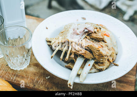 Bollito di agnello in una piastra su una tavola di legno Foto Stock