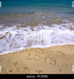 Anno Nuovo 2019 è venuta concetto - iscrizione 2018 e 2019 su una spiaggia di sabbia, l'onda sta iniziando a coprire le cifre 2018. Spazio di copia, piana, laici top Foto Stock