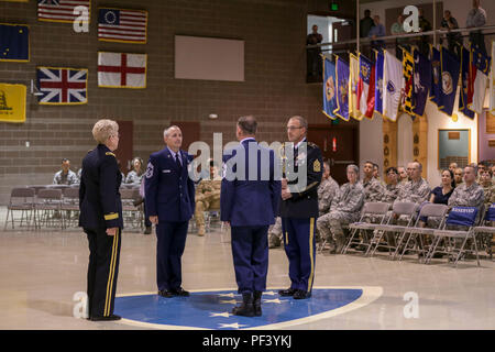 Master Chief Sgt. Paolo Nelson rinuncia a responsabilità come senior leader arruolato per l'aiutante generale di Alaska, il Mag. Gen. Laurie Hummel, Chief Master Sgt. Winfield Hinkley, Jr. durante un mese di agosto 13, 2018 di cambiamento di responsabilità cerimonia in Alaska National Guard Armory su base comune Elmendorf-Richardson. (U.S. Esercito nazionale Guard foto di Balinda O'Neal Dresel) Foto Stock