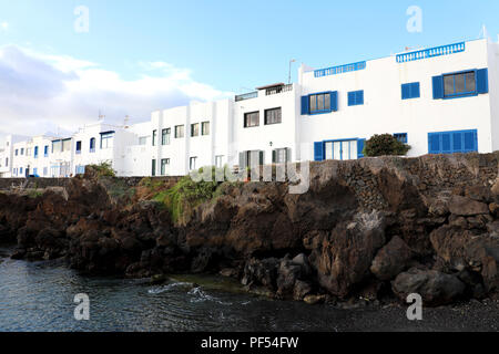 Tipica canaria case bianche a Punta Mujeres sulle rocce del mare, l'isola di Lanzarote Foto Stock