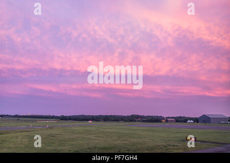 Dulles, Stati Uniti d'America - 13 Giugno 2018: Dulles Internation Airport, IAD, pista con codice colorato di rosa drammatico tramonto rosso nel campo della Virginia Foto Stock