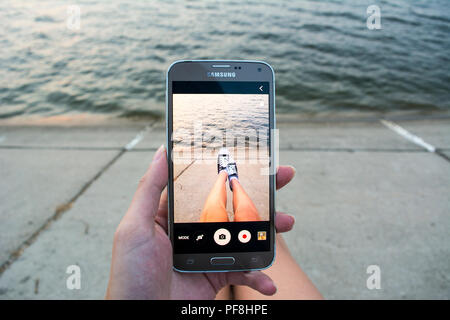 19 agosto 2018-Bucarest, Romania. Una ragazza di scattare foto con il suo telefono Samsung Foto Stock