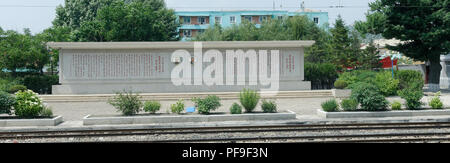 Ritratti di Kim Ll-Sung e Kim Jong adornano ogni treno stazione ferroviaria in Corea del Nord. Spesso con le citazioni della loro saggezza accanto a loro. Foto Stock