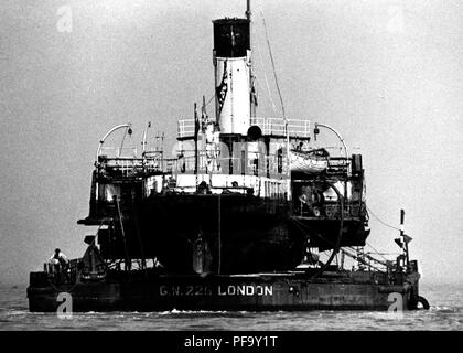 AJAXNETPHOTO. 20Aprile, 1984. COWES, Isola di Wight in Inghilterra. - La regina ottiene un ascensore - IL BATTELLO A VAPORE MEDWAY REGINA caricato su un pontone, trainato fuori del fiume MEDINA in rotta per il Tamigi. Foto:JONATHAN EASTLAND/AJAX REF:842004 1 Foto Stock