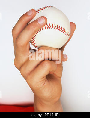 Mano che tiene palla da baseball, close up Foto Stock