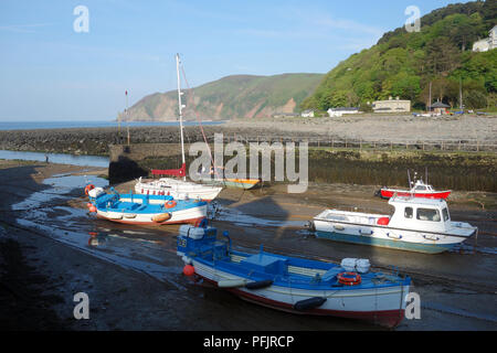 Barca a vela, barche da pesca e da diporto ormeggiata nel porto di Lynmouth al tramonto sul sud-ovest sentiero costiero, Somerset, Inghilterra, Regno Unito. Foto Stock