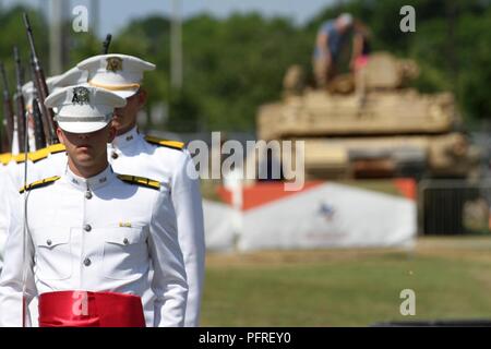 COLLEGE STATION, Texas-membri della Texas A&M Ross volontari a prepararsi per un 21-gun salute mentre i visitatori per saperne di più su M1 Abrams serbatoio (fondo) durante la sessione inaugurale del Texas Weekend del ricordo qui, 26 maggio. Il weekend lungo evento si è svolto al fine di onorare quei militari che hanno pagato il sacrificio estremo. Foto Stock