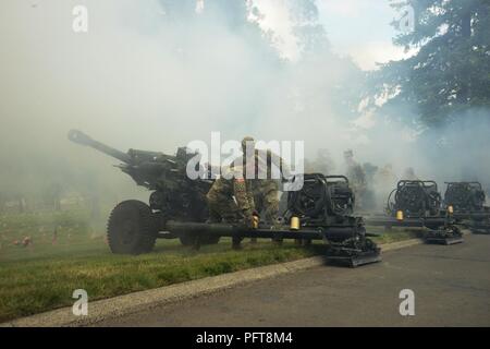 Oregon Esercito Nazionale soldati di guardia di una batteria, 2° Battaglione, campo 218th reggimento di artiglieria, XLI della brigata di fanteria combattere la squadra, fuoco loro M119 Obici come parte del Memorial Day programma a Willamette Cimitero Nazionale di Portland, Oregon, 28 maggio 2018. (Guardia Nazionale Foto Stock