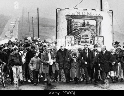 La chiusura della miniera di carbone Maerdy l'ultimo pit nella Rhondda Valley. Minatori del carbone con le loro famiglie i consiglieri locali politici e sostenitori marzo dalla profonda miniera il giorno è chiusa sotto l Unione Nazionale dei minatori Maerdy Lodge banner. Foto Stock