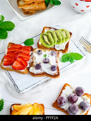 French Toast con formaggio a pasta morbida, fragole, kiwi, ciliegie e mirtilli, vista dall'alto Foto Stock