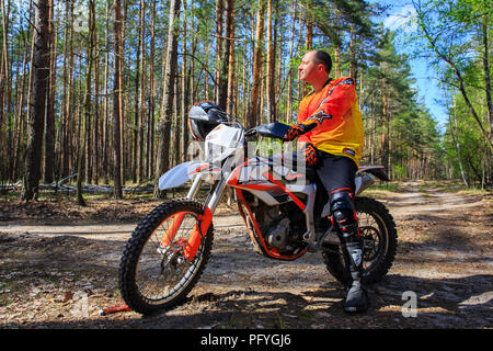 A piedi a una moto sportiva nella foresta. Foto Stock