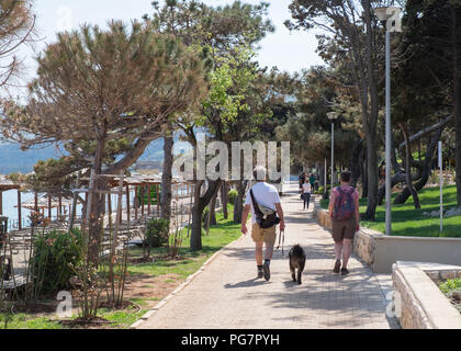 Coppia di anziani a piedi lungo il lungomare,Rabac in Istria, Croazia. Foto Stock