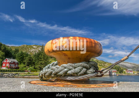 Di spessore di rusty bollard arancione su un molo in Norvegia. Foto Stock