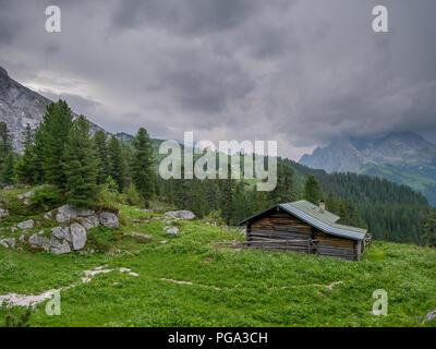 Cabina di legno nelle alpi bavaresi con le tempeste in background Foto Stock