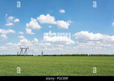 Le linee ad alta tensione in un campo sullo sfondo di un cielo nuvoloso, Moldavia Foto Stock