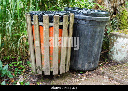Un vassoio di legno e di plastica nero bin in una foresta Foto Stock