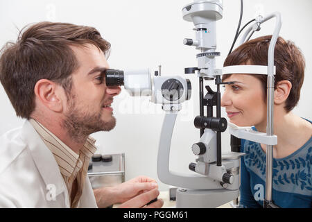 La chirurgia di un oftalmologo durante il controllo della retina di un paziente, esame con lampada a fessura Foto Stock