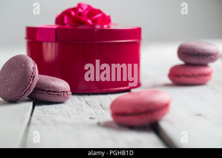 Gruppo di macarons fatta di fragole, crema, cioccolato e mirtilli. Foto rustico. Macro. Foto Stock