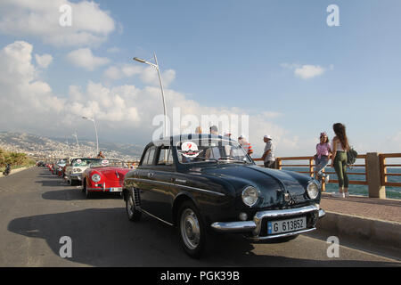 Beirut, Lebannon. 26 Ago, 2018. La gente guarda la collezione Classic Cars Parade 2018 presso il villaggio di Amchit, a nord di Beirut, Lebannon, su agosto 26, 2018. Più di 60 automobili classiche databile fra gli anni quaranta e la fine degli anni settanta ha sfilato per il quinto anno consecutivo qui di domenica. Credito: Bilal Jawich/Xinhua/Alamy Live News Foto Stock