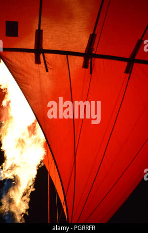 In mongolfiera ad aria calda con un fuoco giallo da un bruciatore di notte, il fuoco e la mongolfiera Foto Stock
