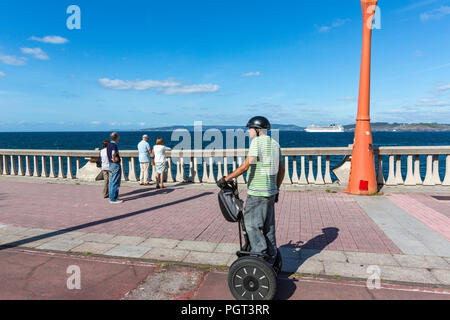 Uomo con Segway e le persone che visualizzano il MSC Magnifica nave da crociera lasciando A Coruña, Galizia, Spagna Foto Stock