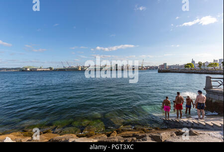 I giovani avente vasca da bagno nel porto il Paseo Maritimo, Promenade e il castello di San Anton, in A Coruña, Galizia, Spagna Foto Stock