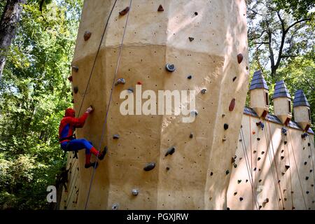 Spiderman su un muro di roccia da scalare al Renaissance festival del Maryland Foto Stock