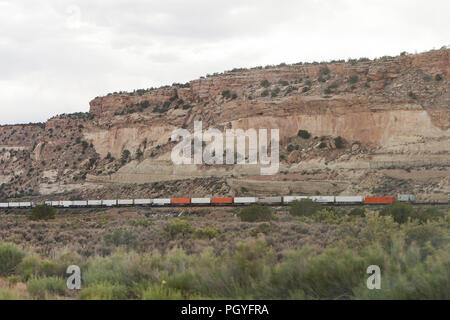 Auto e treno che viaggia attraverso il deserto rurale - Arizona USA Foto Stock