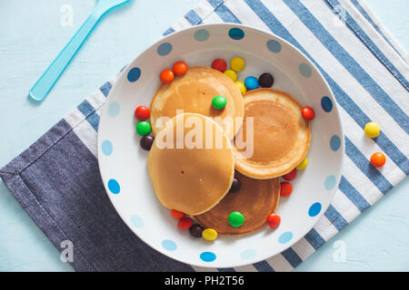 Colazione per bambini o dessert - pancake con caramelle colorate. Foto Stock